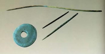 photo of Earthen spining wheel, bone needles and bone shuttle